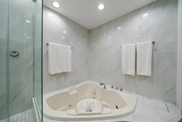 a bathroom with a bathtub and shower