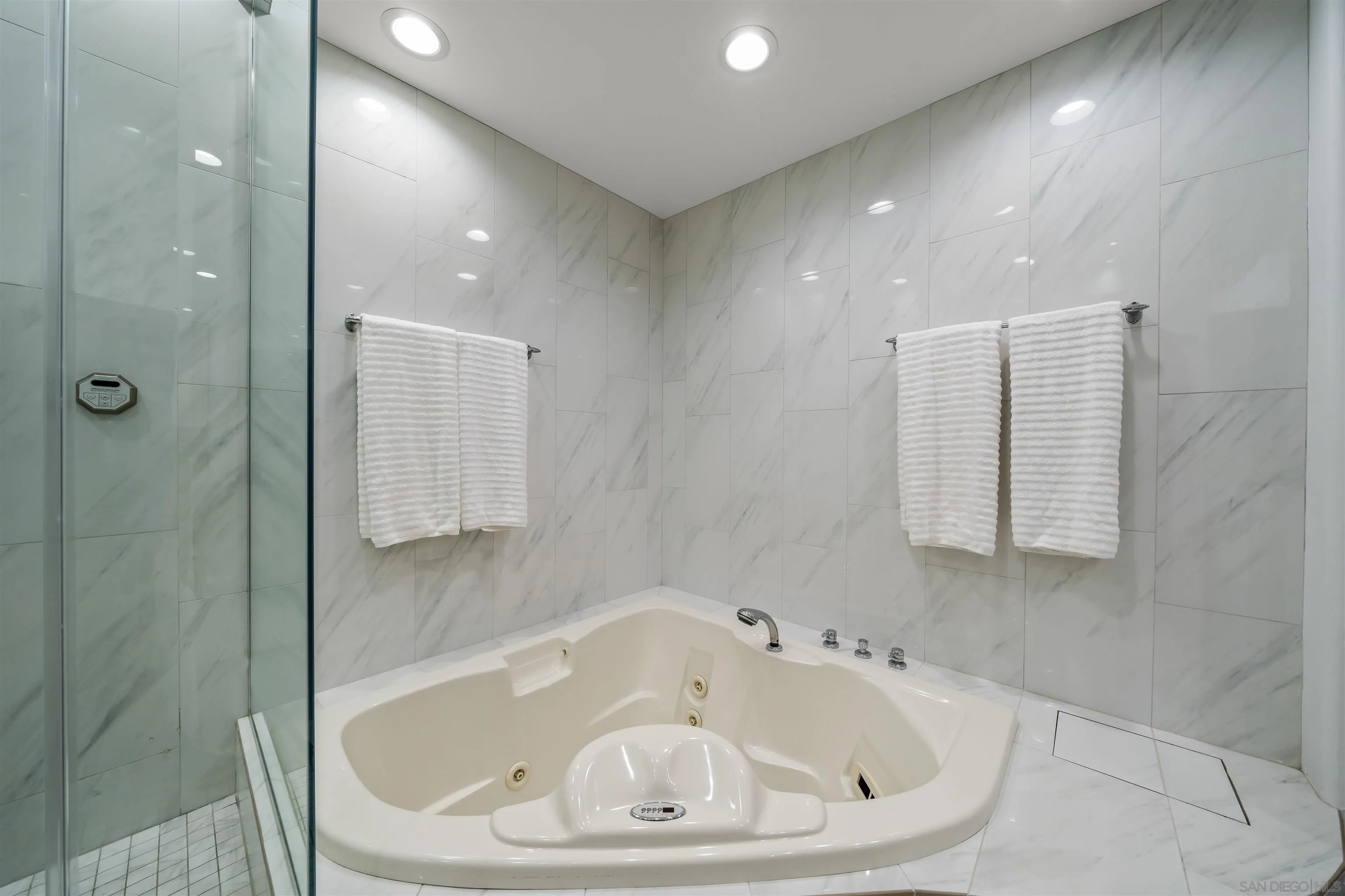 2999 Ocean Front Walk, Unit 1 San Diego, CA 92109 - Photo 25 of 37 a bathroom with a bathtub and shower