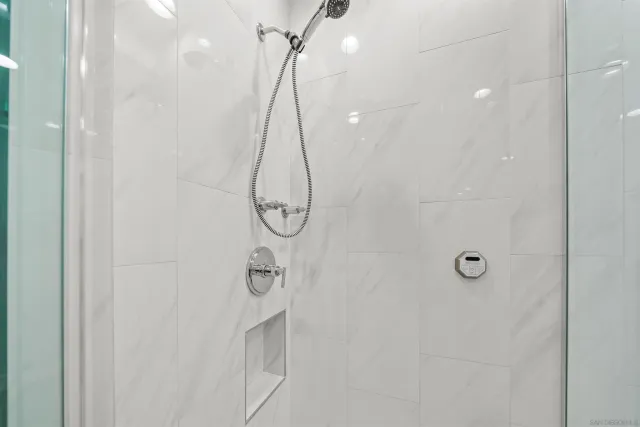a bathroom with a shower and a shower head