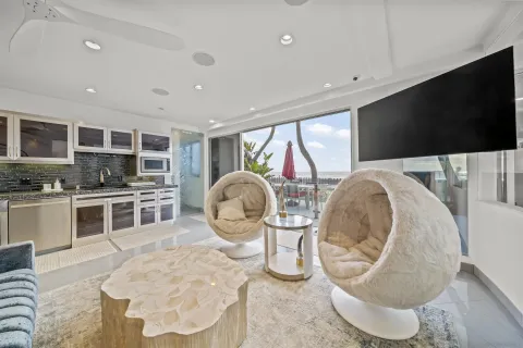 a kitchen with furniture and a flat screen tv