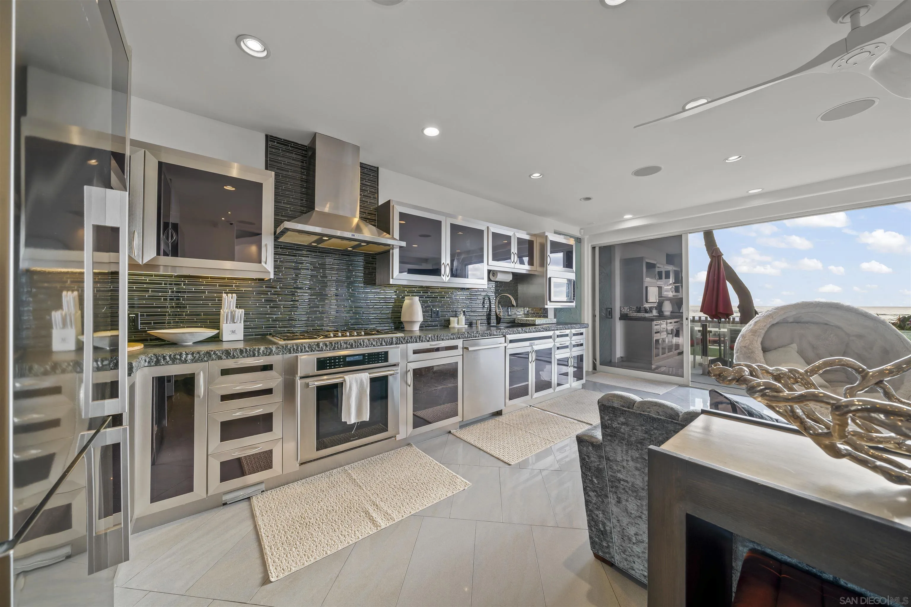 2999 Ocean Front Walk, Unit 1 San Diego, CA 92109 - Photo 5 of 37 a large kitchen with stainless steel appliances granite countertop a stove and a sink