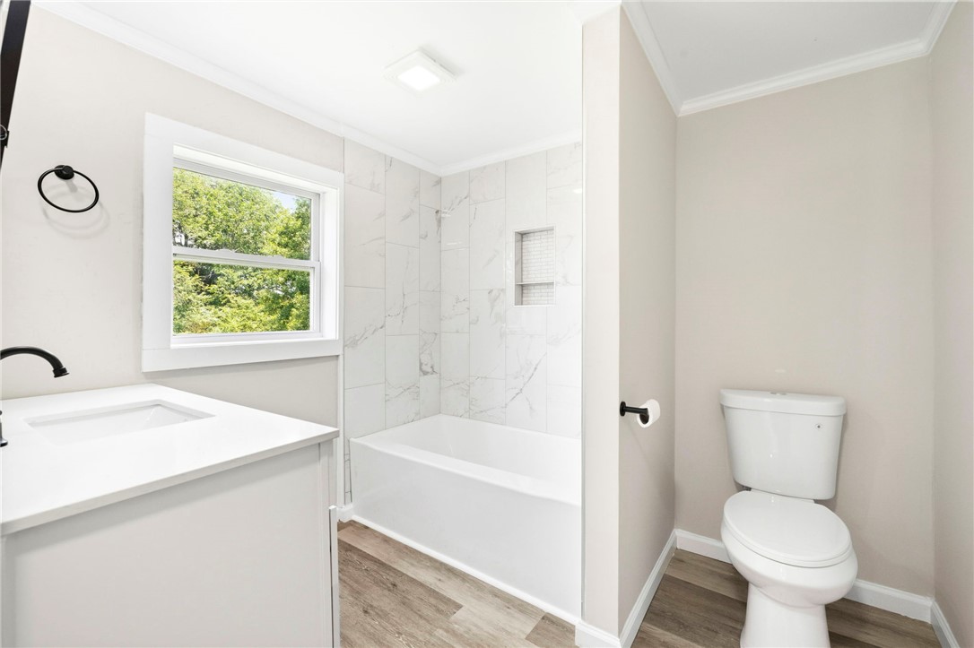 418 Old River Road Pelzer, SC 29669 - Photo 13 of 29 Modern full bathroom with a spacious tub and shower combination, set against a backdrop of crisp white and neutral tones.