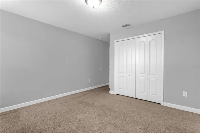 a view of an empty room and closet area