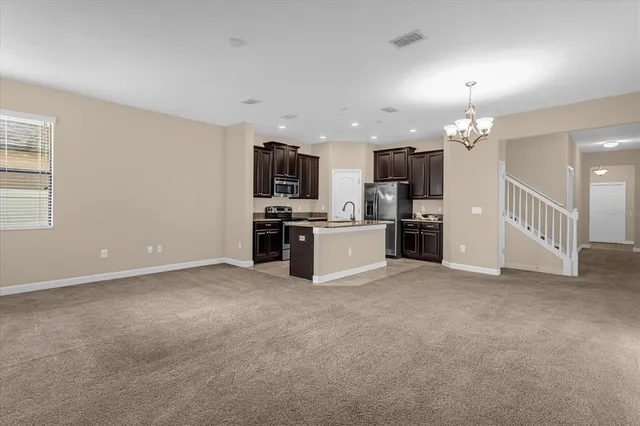 a view of a kitchen with a sink and a refrigerator