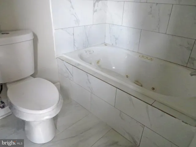 a white toilet sitting next to a white sink