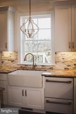 a kitchen with granite countertop a sink and a window