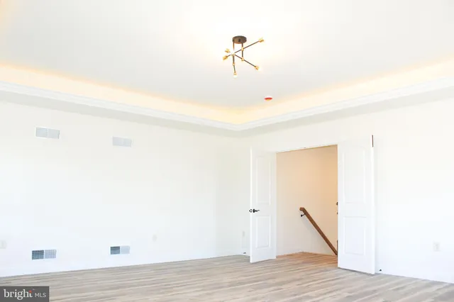 a view of a room with wooden floor