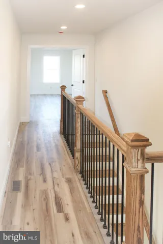 a view of hallway with wooden floor