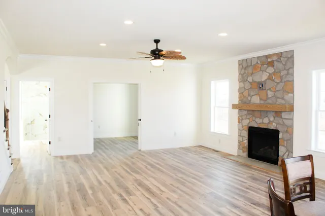wooden floor in an empty room with a fireplace