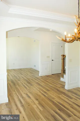 a view of a room with wooden floor