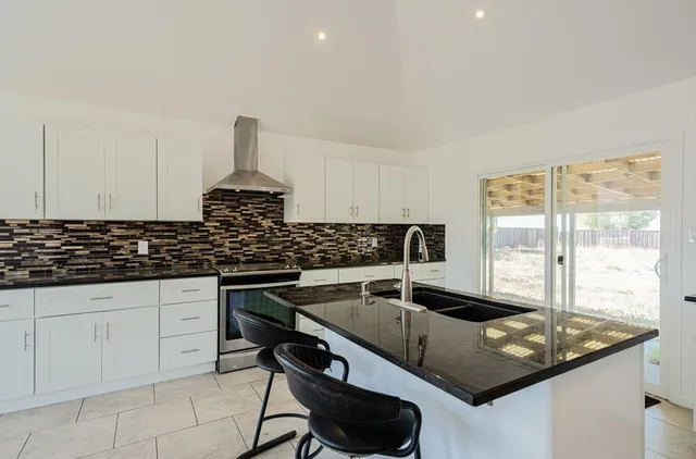 a view of a hallway with a chandelier fan