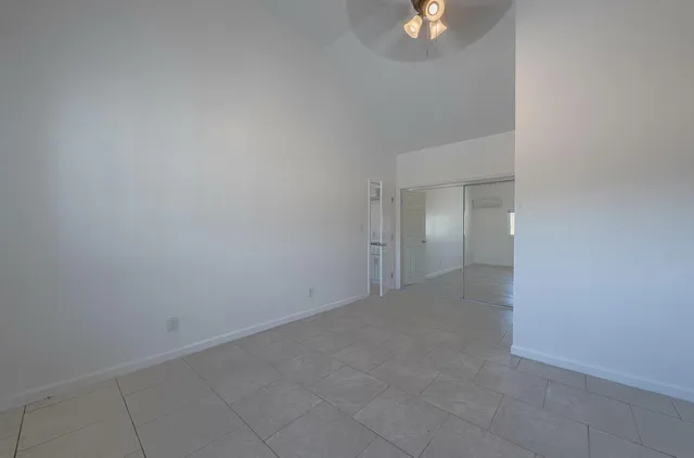 an empty room with cabinet and mirrors