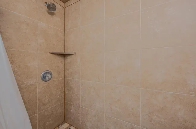 a kitchen with granite countertop white cabinets and refrigerator