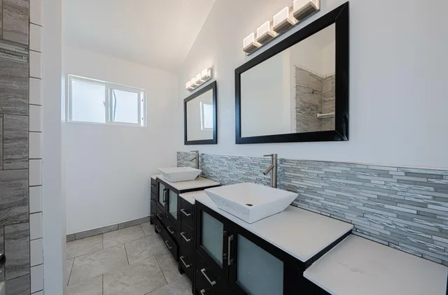 a kitchen with a stove sink and cabinets