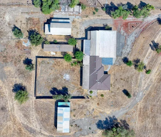 an aerial view of a house with a yard and lake view