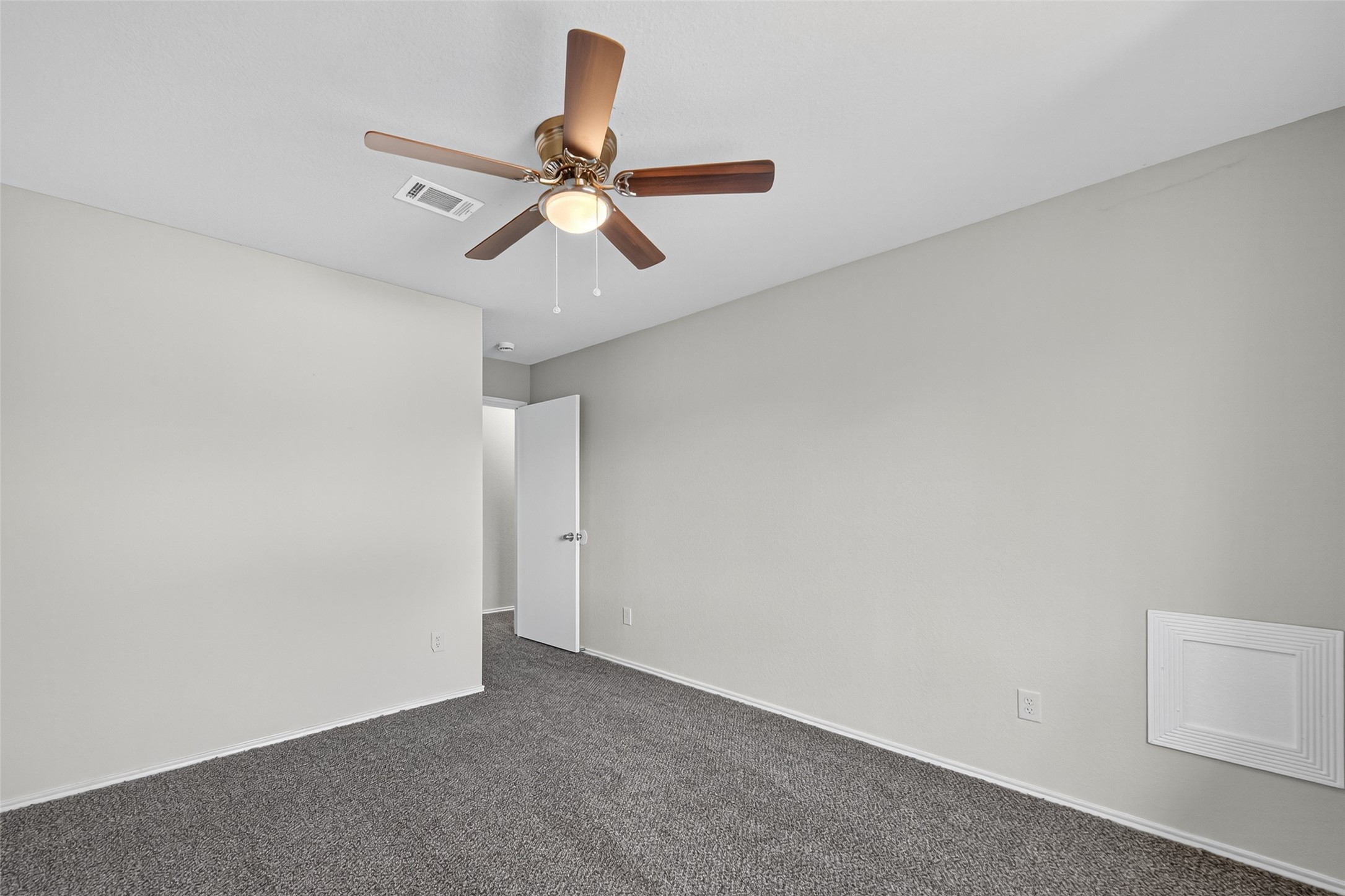7926 Sundance Court Baytown, TX 77521 - Photo 18 of 32 an empty room with a ceiling fan and wooden floor