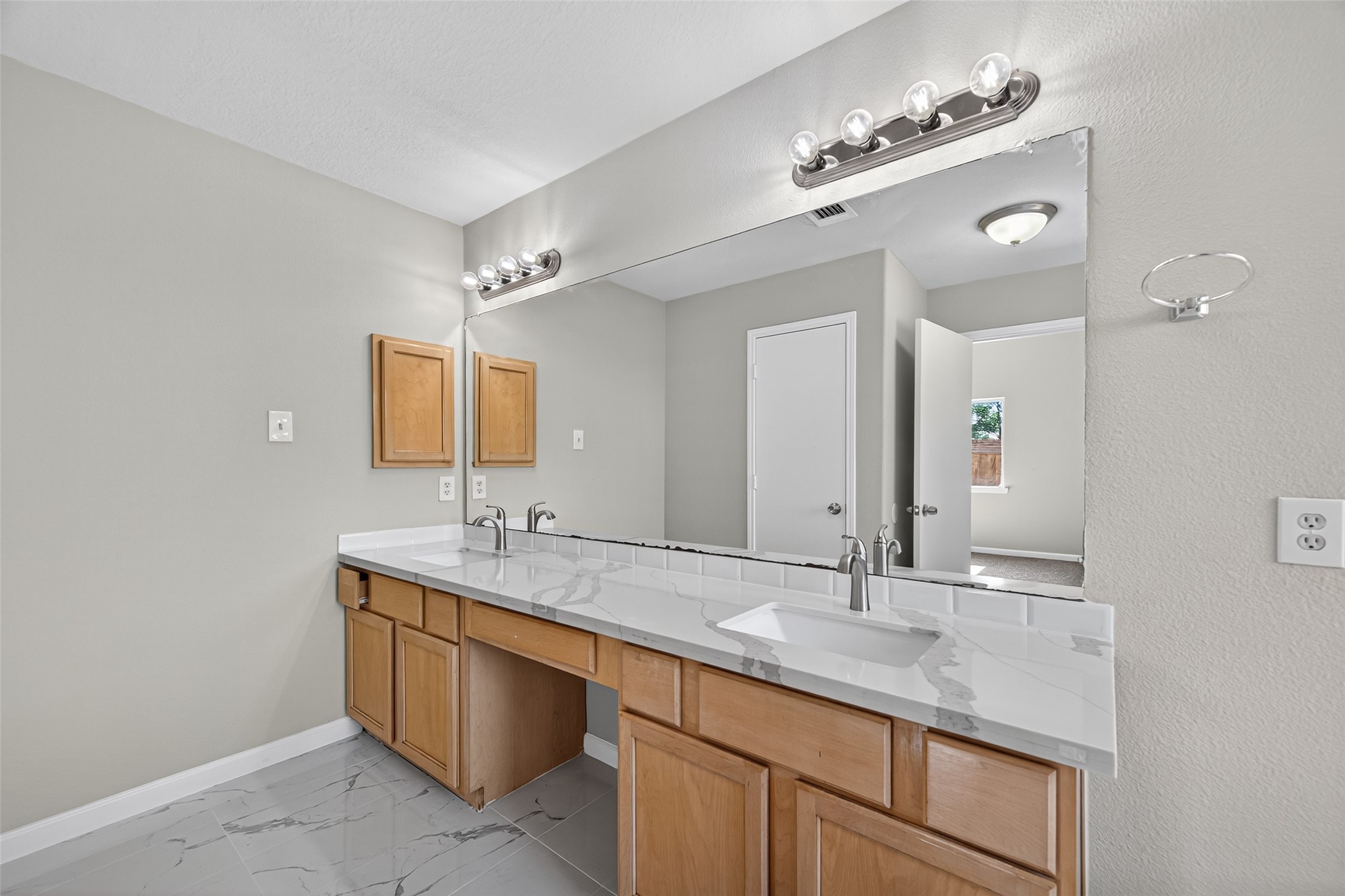 7926 Sundance Court Baytown, TX 77521 - Photo 27 of 32 a bathroom with a sink double vanity and a mirror