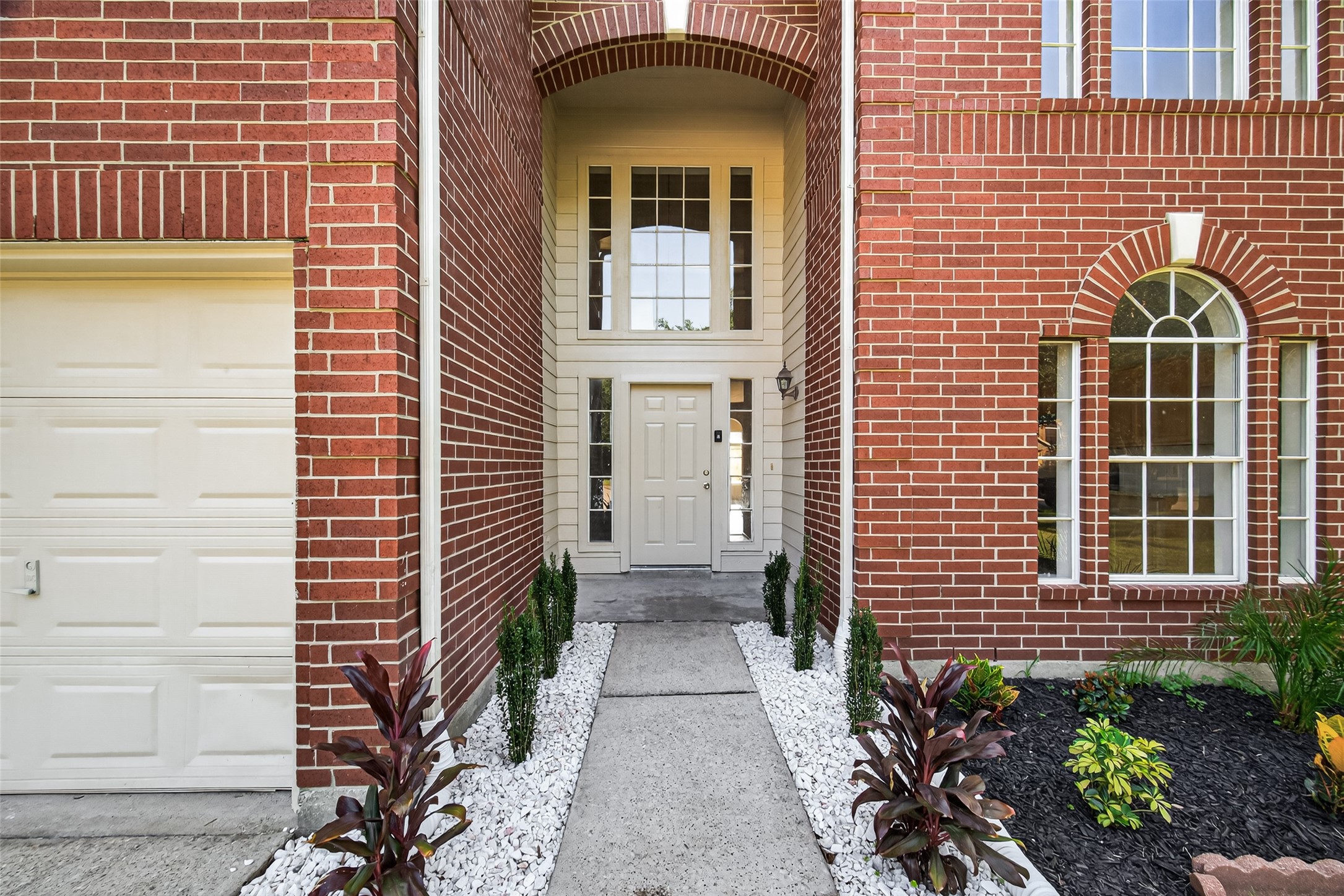 7926 Sundance Court Baytown, TX 77521 - Photo 2 of 32 a view of a brick house with many windows