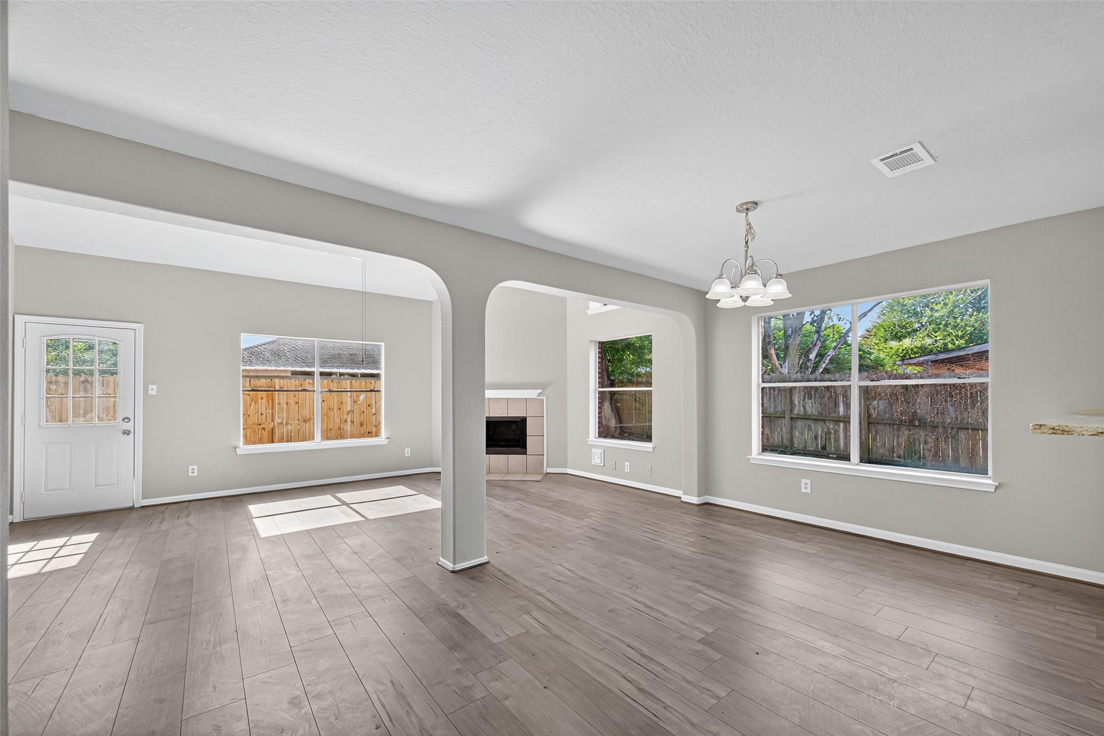 7926 Sundance Court Baytown, TX 77521 - Photo 4 of 32 a view of an empty room with wooden floor and a window