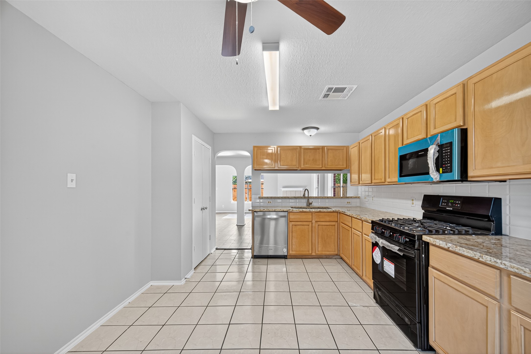 7926 Sundance Court Baytown, TX 77521 - Photo 8 of 32 a kitchen with stainless steel appliances granite countertop a stove sink and cabinets