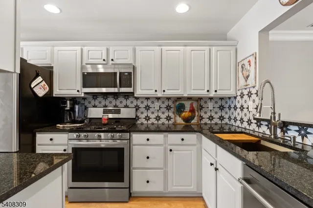 a kitchen with granite countertop a stove and a sink