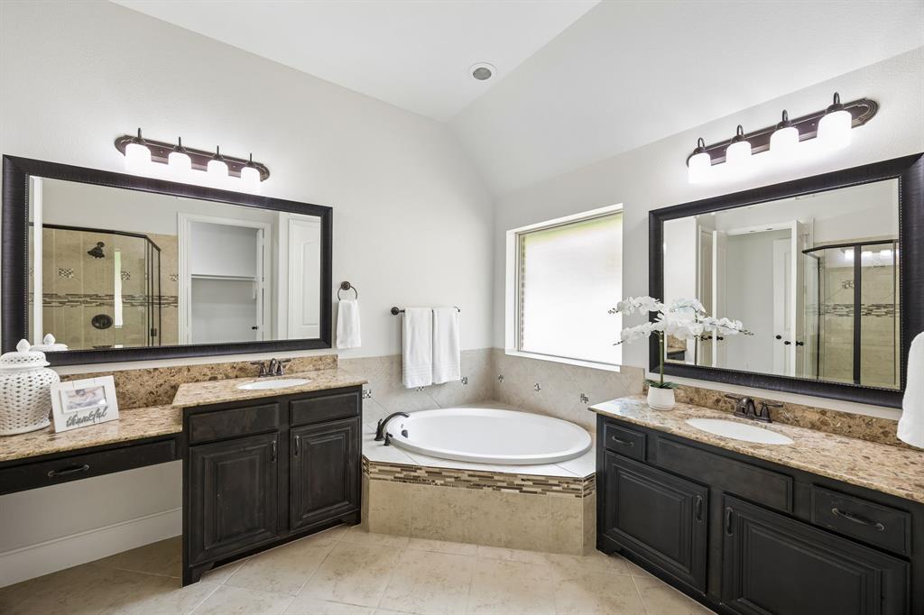 1567 Red Rock Canyon Road Frisco, TX 75036 - Photo 20 of 36 Primary bathroom has two vanities and garden tub. Framed mirrors.