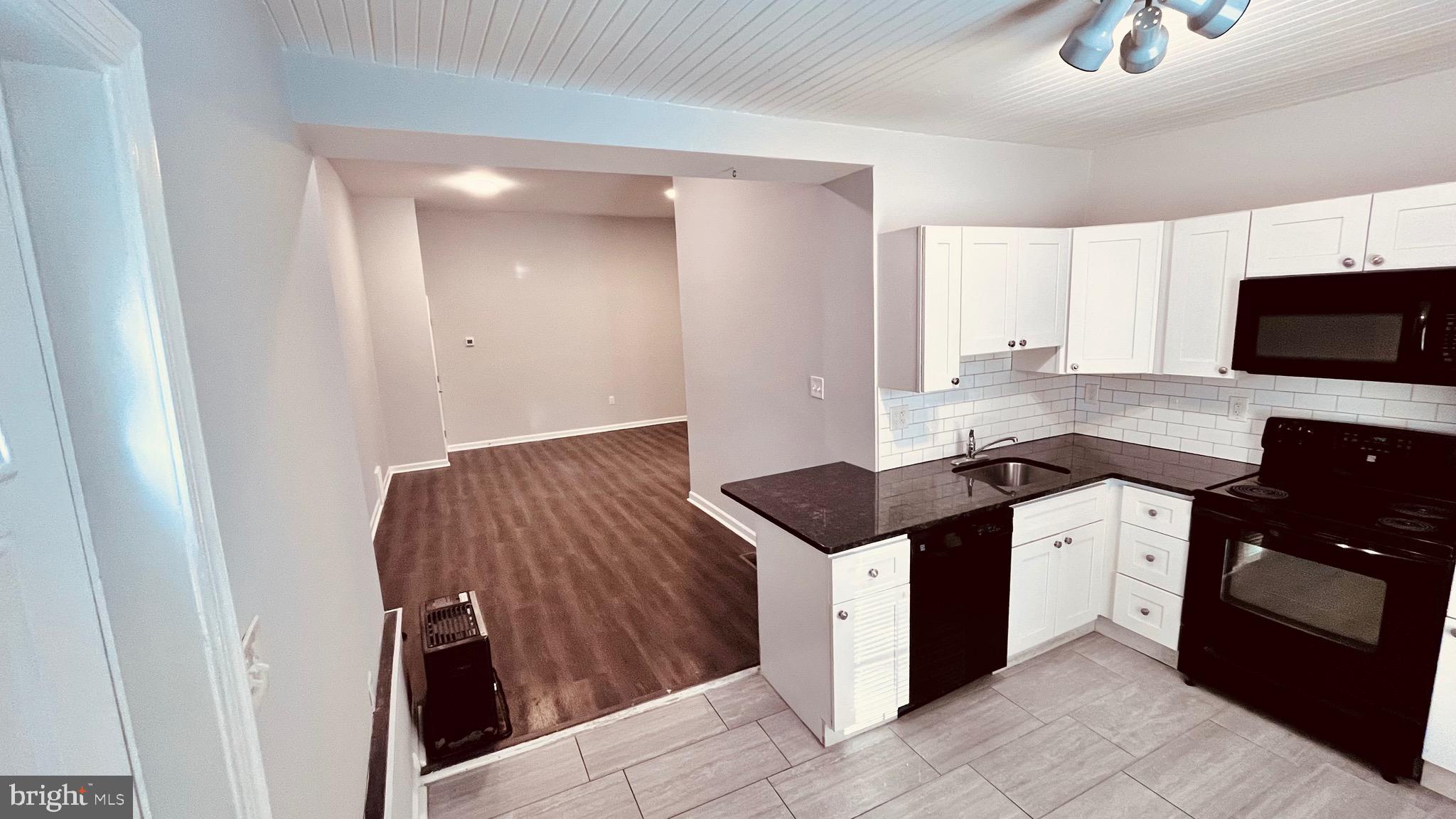 a kitchen with a sink and a refrigerator