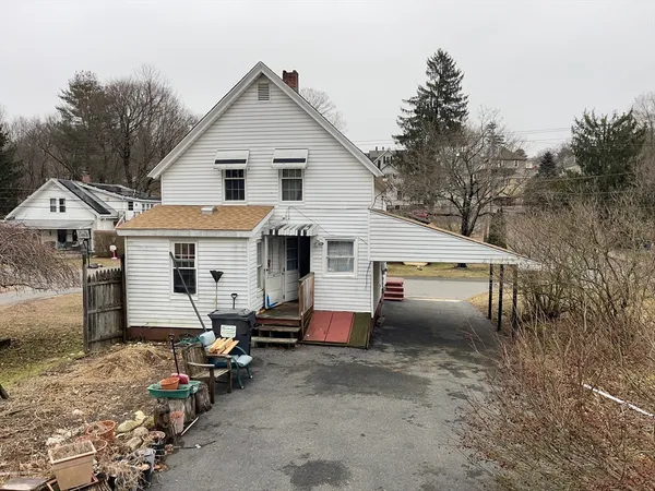 a view of a white house with a yard and garage