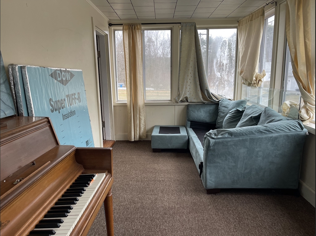 76 Aspen Street Ware, MA 01082 - Photo 9 of 25 a living room with furniture and a piano