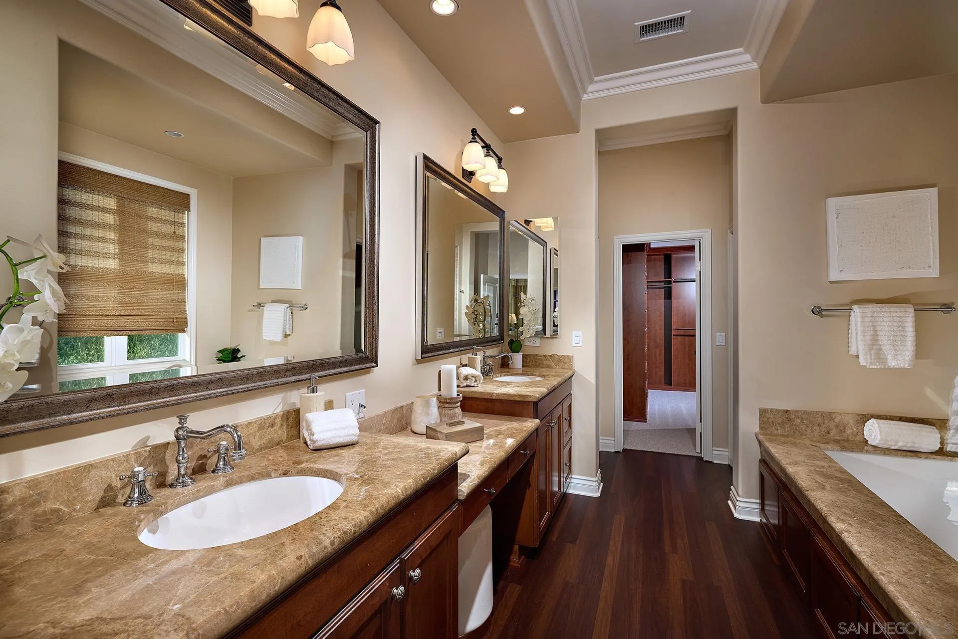 6615 Halite Place Carlsbad, CA 92009 - Photo 17 of 56 a spacious bathroom with a granite countertop double vanity sink a mirror and a shower