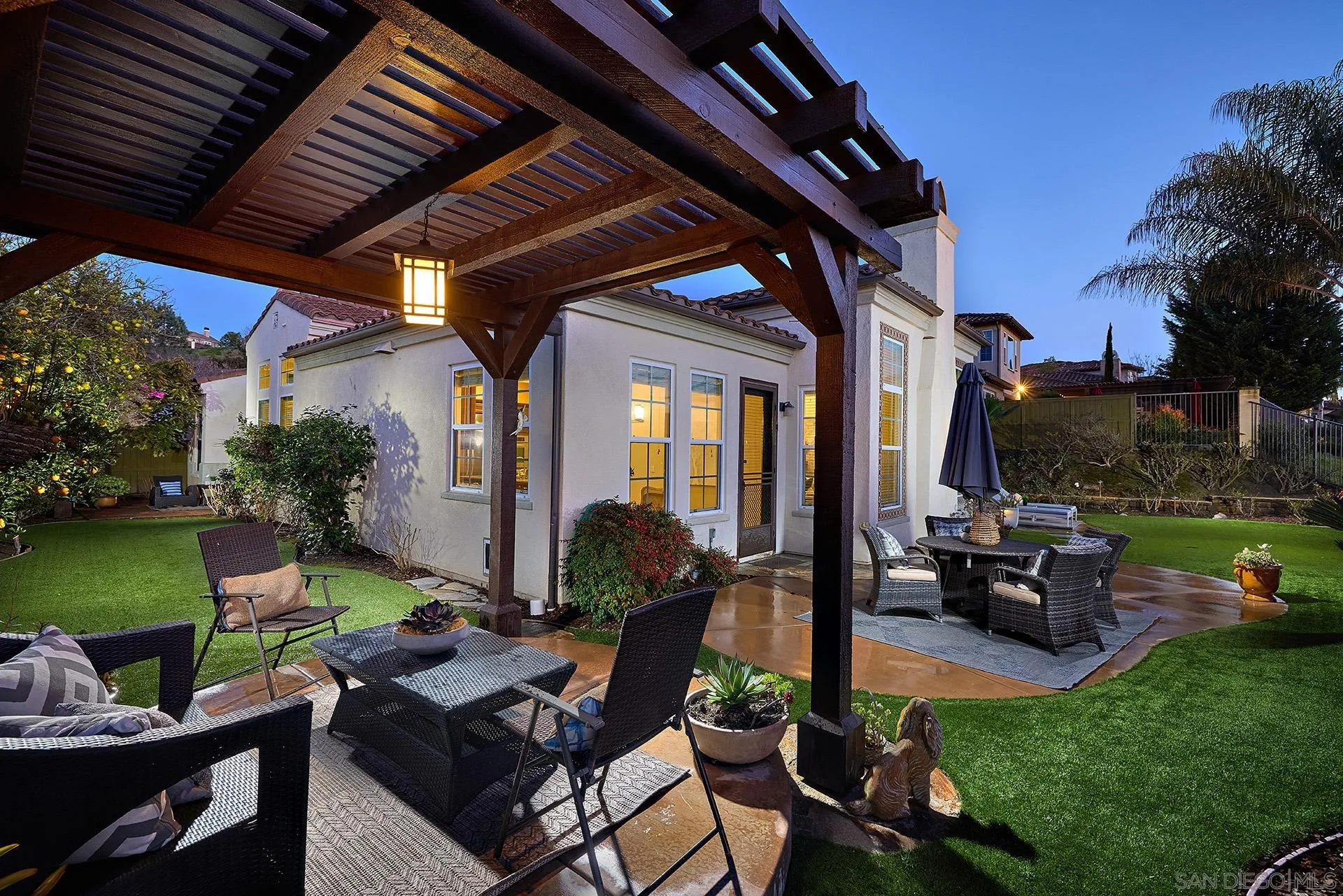 6615 Halite Place Carlsbad, CA 92009 - Photo 25 of 56 a view of a patio with table and chairs potted plants and a large tree