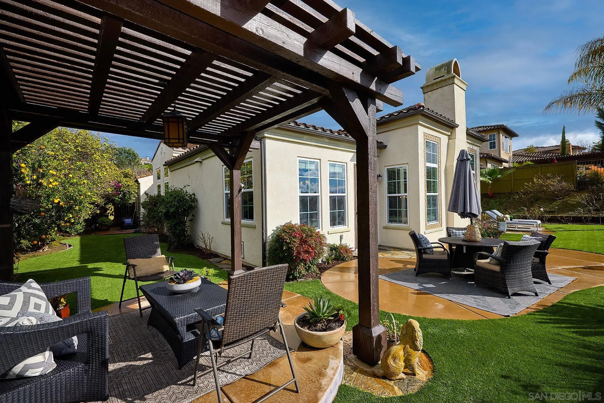 6615 Halite Place Carlsbad, CA 92009 - Photo 30 of 56 a patio with a table and chairs and potted plants
