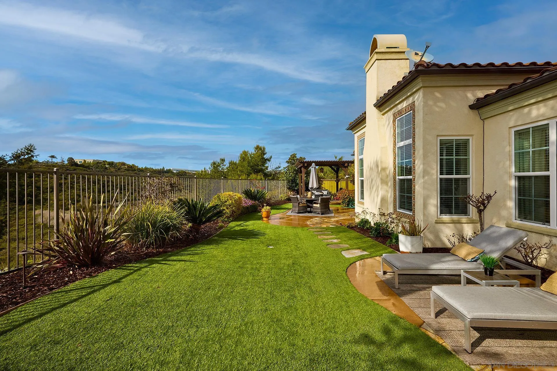 6615 Halite Place Carlsbad, CA 92009 - Photo 35 of 56 a view of a house with backyard sitting area and garden