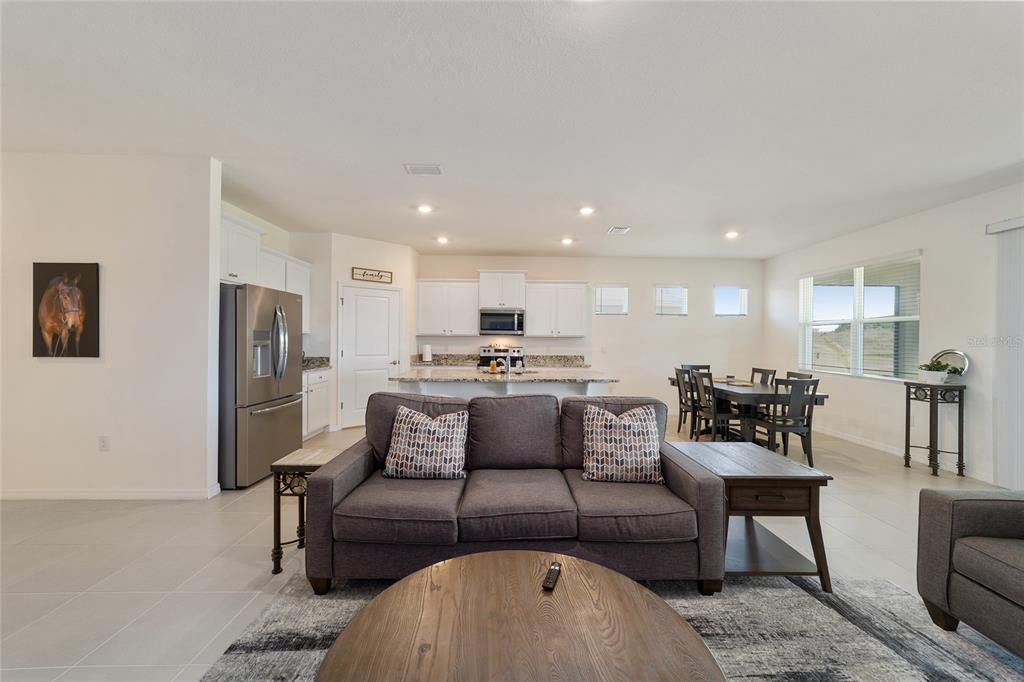 5252 Northwest 46th Lane Road Ocala, FL 34482 - Photo 14 of 51 a living room with furniture and a refrigerator