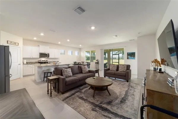 a large kitchen with a table and chairs