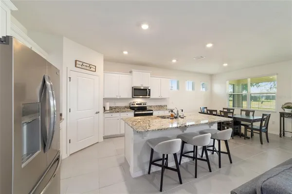 a kitchen with a refrigerator stove and sink