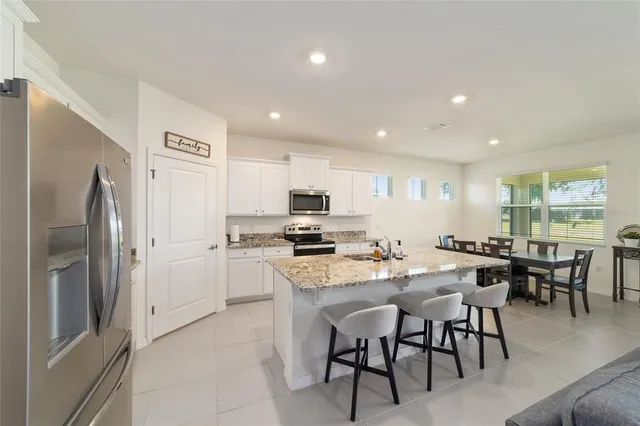 a kitchen with a refrigerator stove and sink