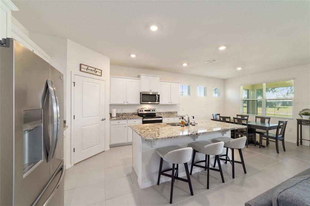 5252 Northwest 46th Lane Road Ocala, FL 34482 - Photo 16 of 51 a large kitchen with a table and chairs