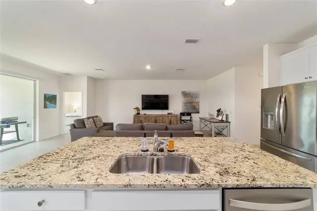 a kitchen with sink stove and refrigerator