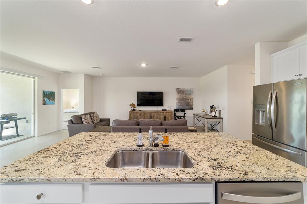 5252 Northwest 46th Lane Road Ocala, FL 34482 - Photo 20 of 51 a living room with granite countertop couches and a flat screen tv