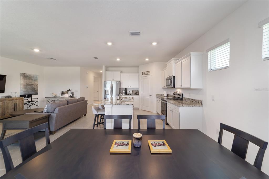 5252 Northwest 46th Lane Road Ocala, FL 34482 - Photo 24 of 51 a living room with furniture and a dining table with kitchen view