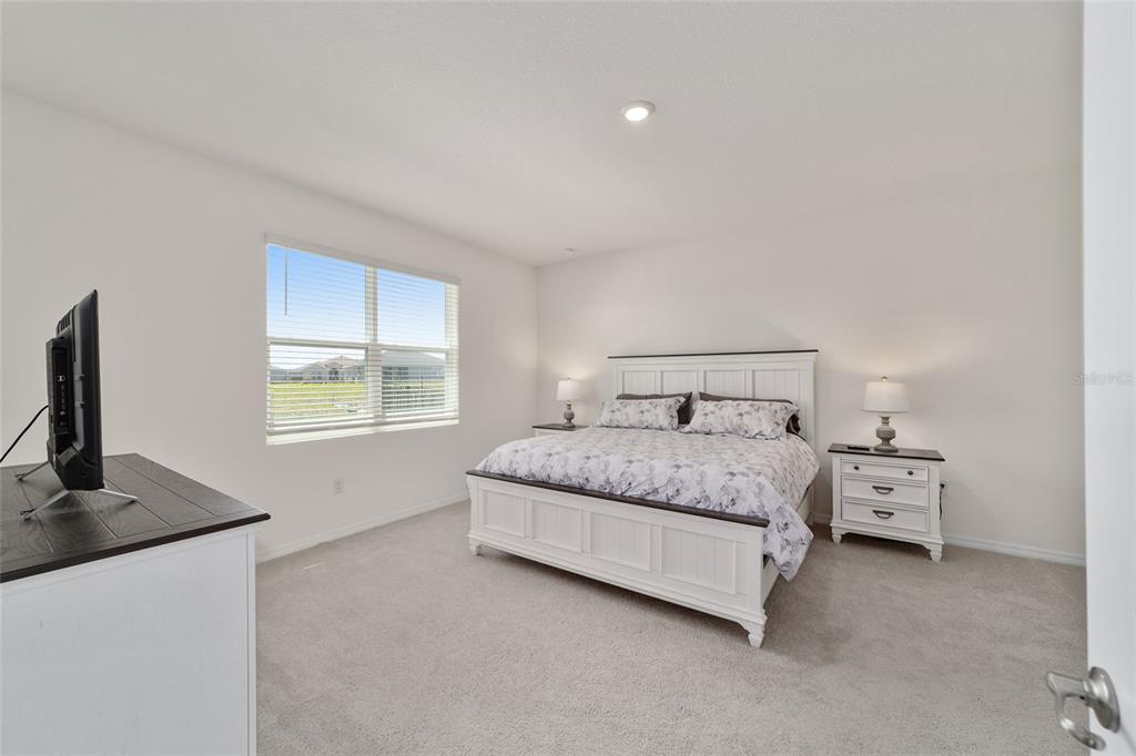 5252 Northwest 46th Lane Road Ocala, FL 34482 - Photo 27 of 51 a bedroom with a bed and a flat screen tv