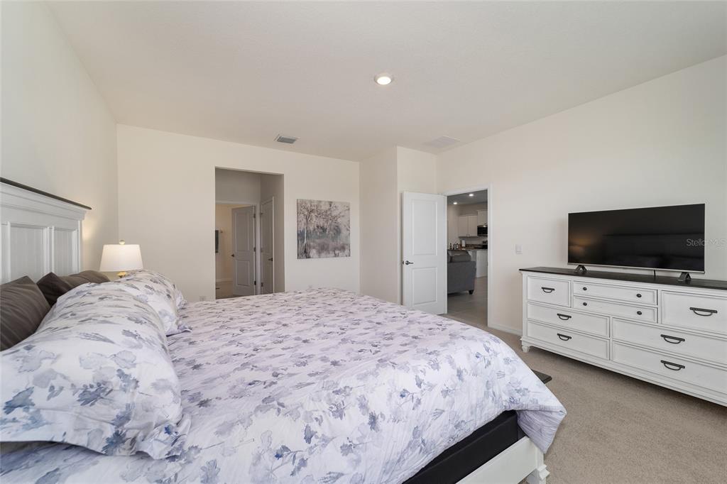 5252 Northwest 46th Lane Road Ocala, FL 34482 - Photo 29 of 51 a bedroom with a bed and a flat screen tv in white dresser