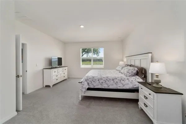 a bathroom with a granite countertop sink a mirror and shower