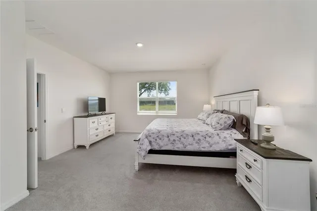 a bathroom with a granite countertop sink a mirror and shower