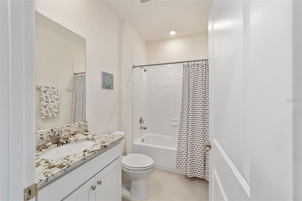 5252 Northwest 46th Lane Road Ocala, FL 34482 - Photo 36 of 51 a bathroom with a granite countertop sink toilet and shower