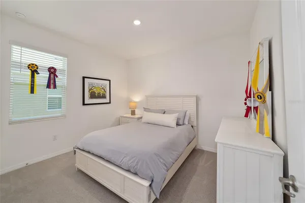 a bedroom with two beds and a window