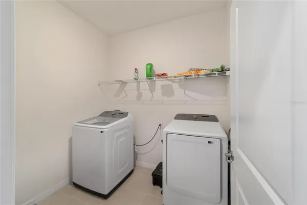 a living room with a floor to ceiling window and pool table