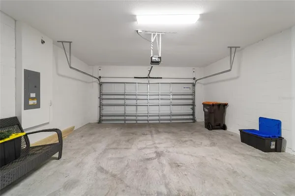 a living room with furniture floor to ceiling window and an outdoor view