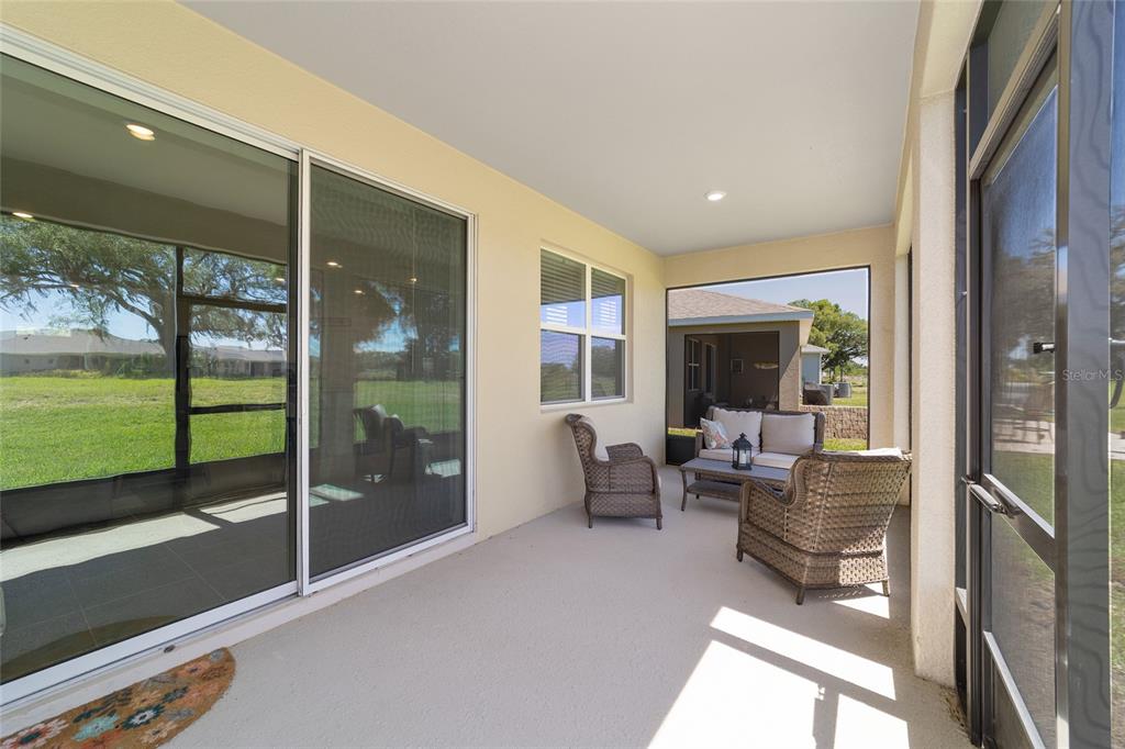 5252 Northwest 46th Lane Road Ocala, FL 34482 - Photo 45 of 51 a living room with furniture floor to ceiling window and an outdoor view